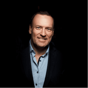 Chase smiles in a black jacket